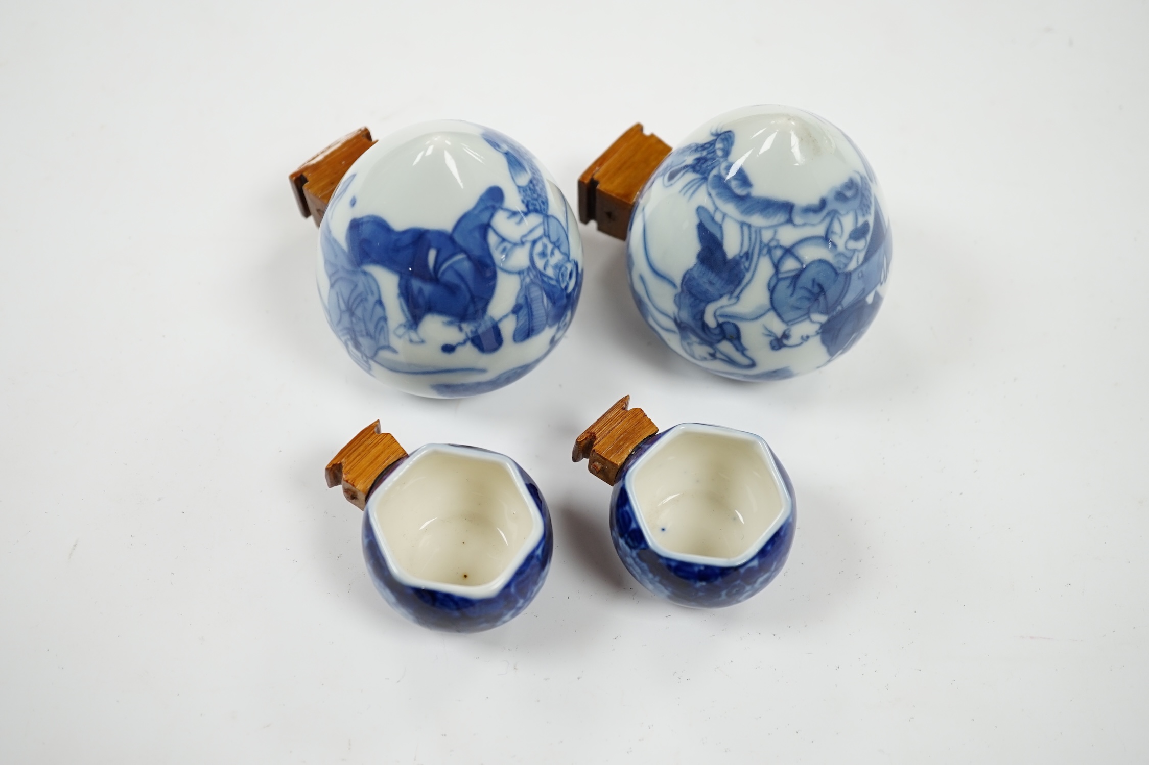 Four Chinese blue and white porcelain bird feeders, largest 7cm high. Condition - good, some glue residue